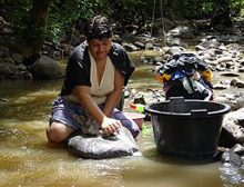 Woman washing clothes in a river in Central America